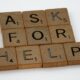 A group of scrabble blocks spelling out "ASK FOR HELP."