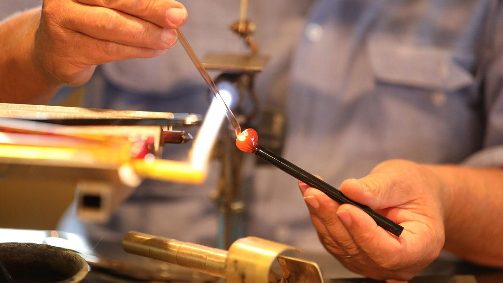 An artisan making Murano Glass jewelry in Murano, Italy