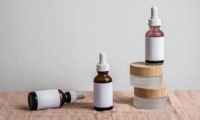 Free Minimalist display of assorted dropper bottles with blank labels on linen surface. Stock Photo